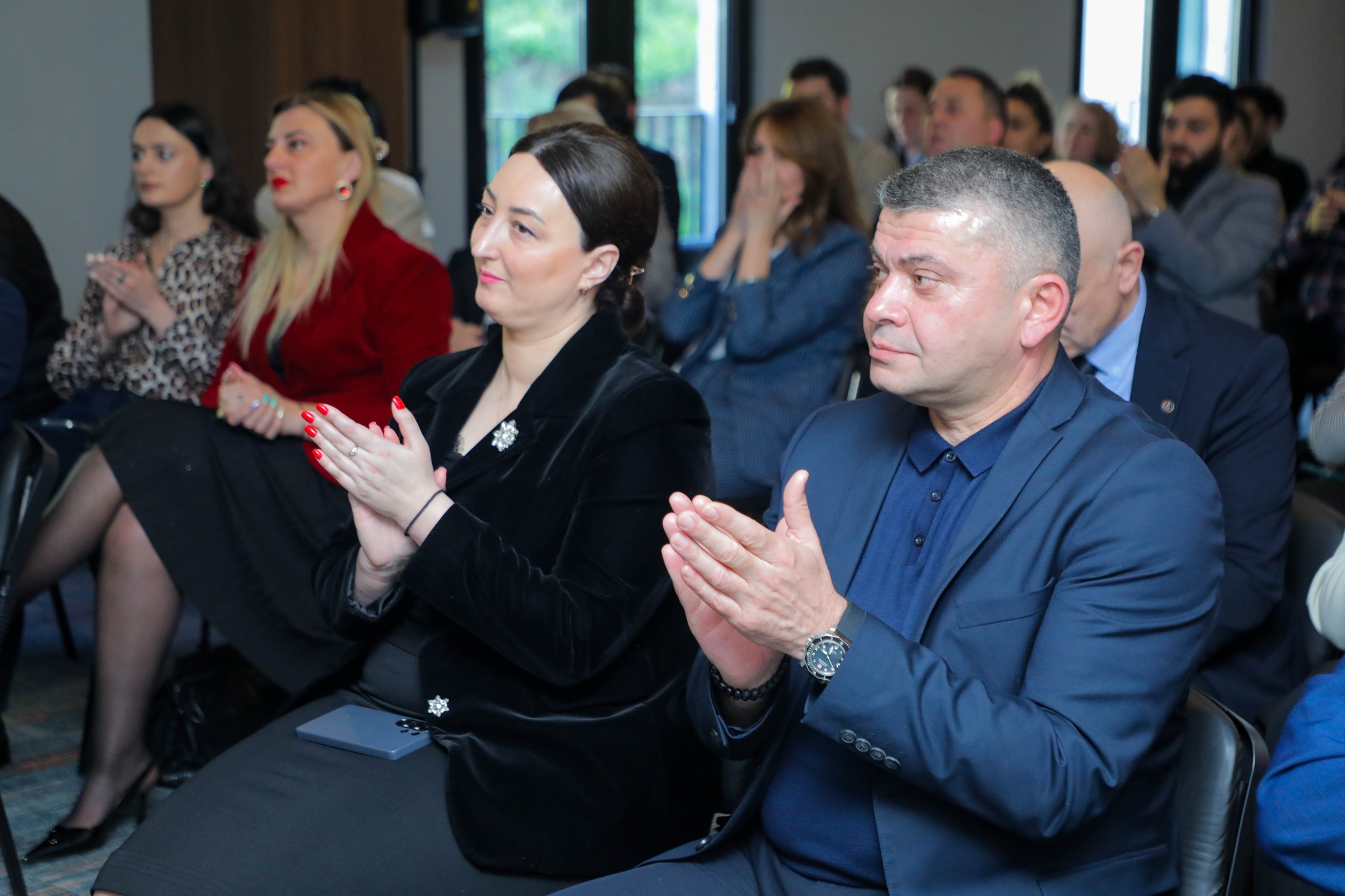 Audience members applauding at a Nebula AI Hub event