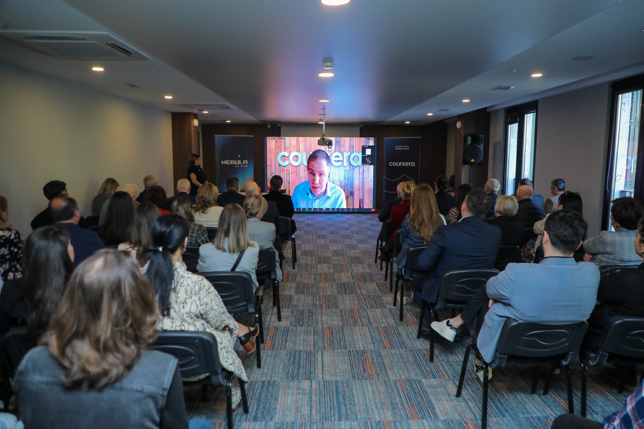Coursera collaboration event at Nebula AI Hub with a full audience