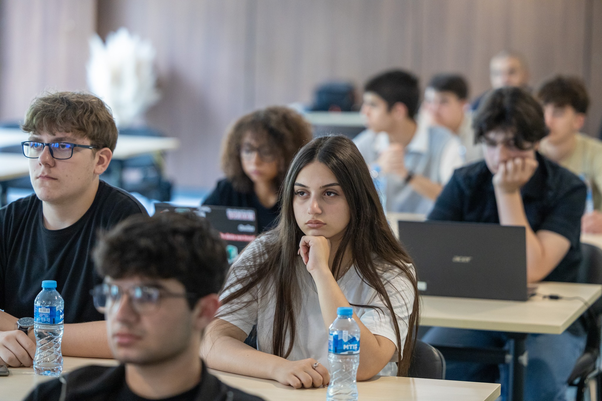 Students attentively focused during an AI course